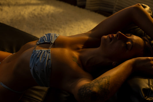 Warm, intimate boudoir pose on a bed photographed in Neenah, Wisconsin.