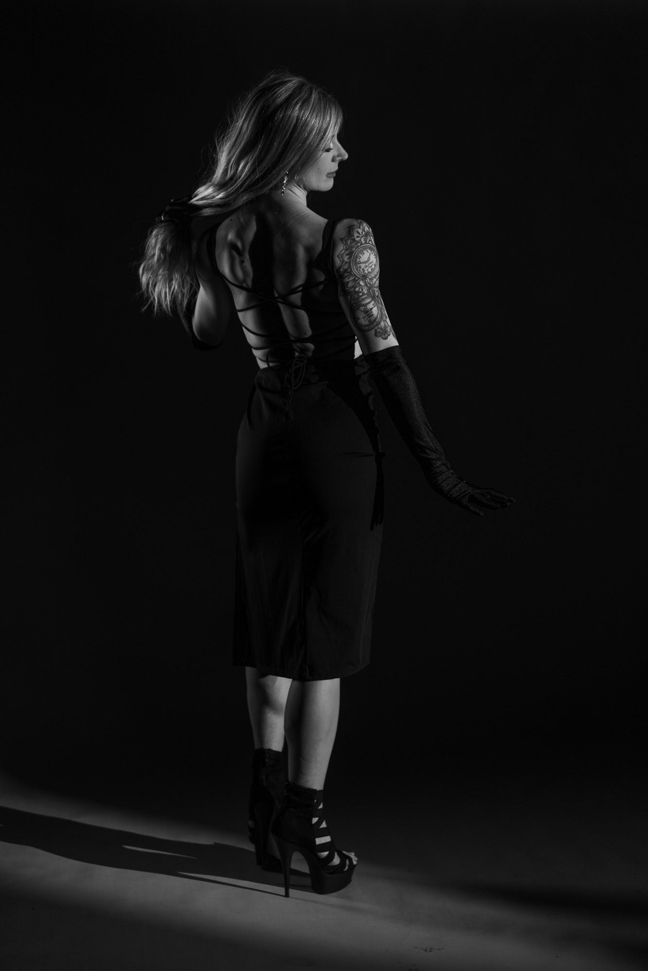 Strong silhouette boudoir pose in dramatic studio lighting at Studio SJ in Neenah, Wisconsin.