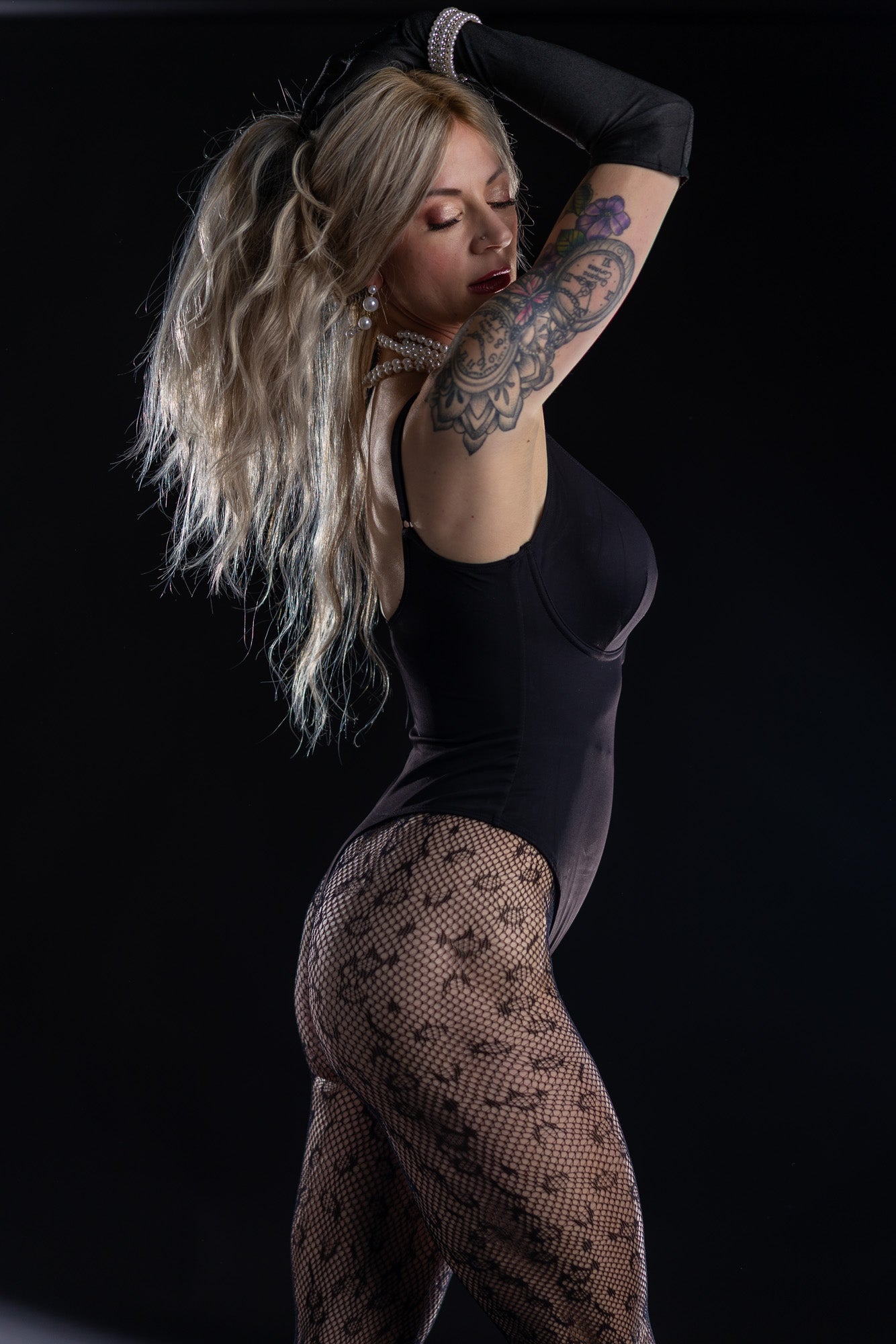 Tattoo-featured boudoir portrait in moody lighting in Neenah, Wisconsin.