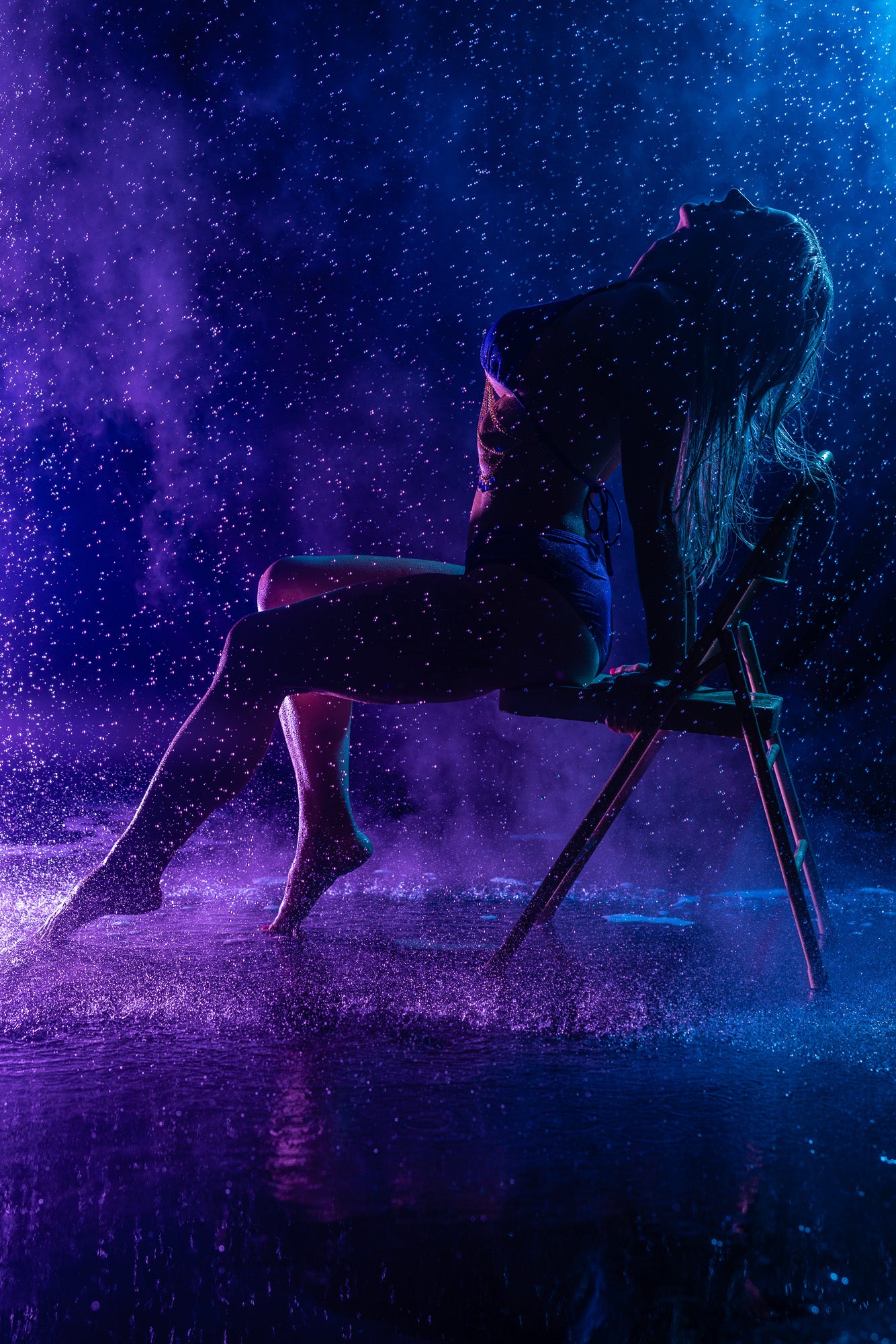 Purple neon rain-themed silhouette on chair.
