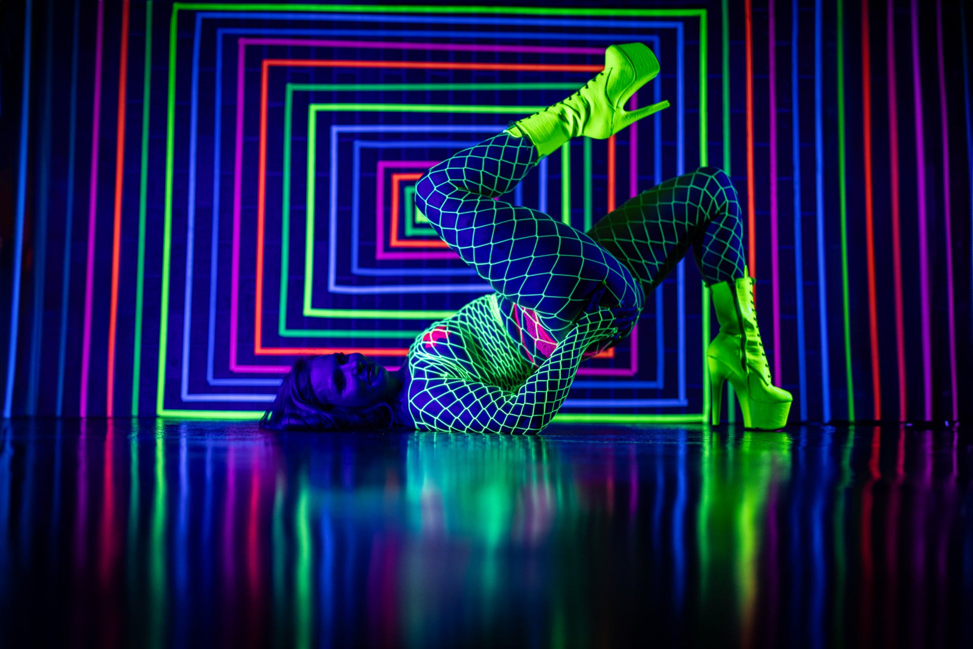 Nightclub-style neon boudoir image with dramatic reflections at Studio SJ in Appleton, WI.