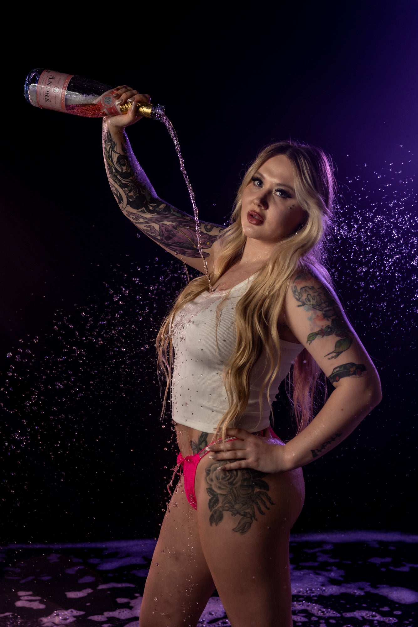 Standing arch boudoir pose with dramatic sculpted lighting.